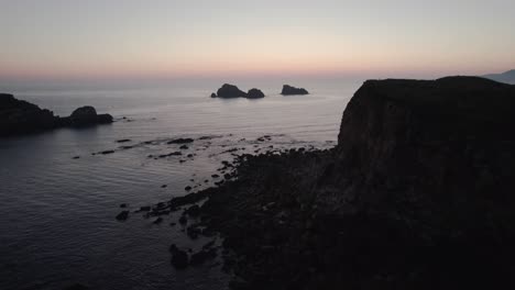 Beautiful-high-cliffs-in-the-calm-Bay-of-Biscay-just-after-a-sunset-in-Suances-in-the-province-of-Cantabria