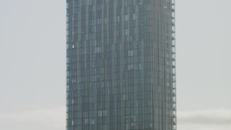 Tilt-down-Beetham-Tower,-Manchester-city-centre-UK,-birds-eye-view