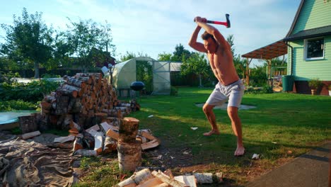 Young-Man-With-Muscular-Body-Chopping-Wood-With-An-Axe