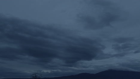 Cludy-Sky-slowly-moving-at-dusk-between-mountains