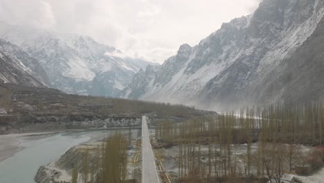Aerial-view-of-lake,-road-tree-and-snow-caped-mountain-of-Hunza-in-Pakistan