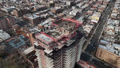 A-high-angle-view-above-a-new-high-rise-construction-site-in-Brooklyn,-NY