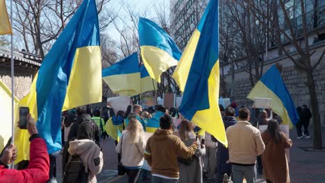 Ukrainians-people-march-protesting-against-Russian-war-in-Seoul-near-Temple---back-view