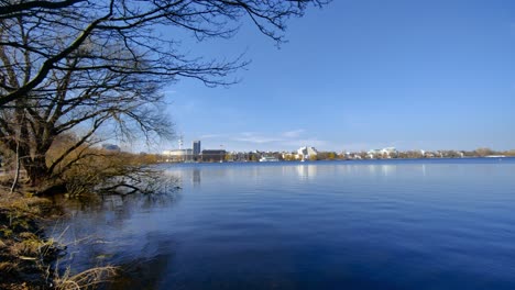 Camera-tilts-up-to-reveal-the-Alster-lake-in-Hamburg-on-a-sunny-day