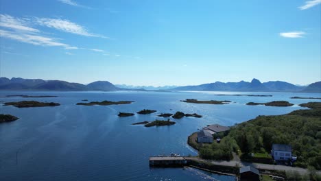 Arial-pan-over-small-Norwegian-harbor-with-panoramic-view-over-small-islands-in-Ringstad-bo-I-Vesteralen---Northern-Norway---Langoya