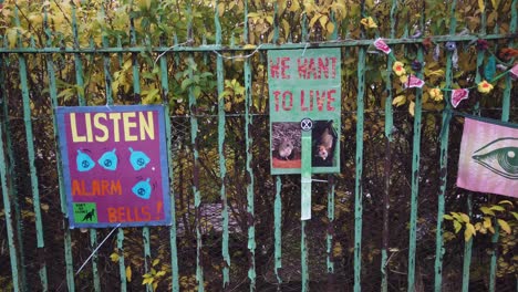 Handmade-climate-change-posters-on-a-park-fence