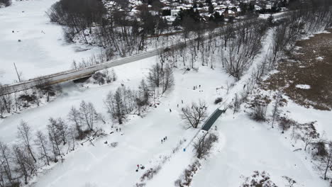 Aerial-of-Ice-Skaters-on-Richardson-Creek,-Green-Ribbon-Trail,-St-Catharines,-Ontario-Canada