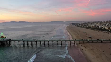 People-Walking-At-Manhattan-Beach-Pier-And-Beach-At-Sunset-In-California,-USA