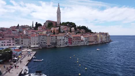 Rovinj-at-Istria,-Croatia---Aerial-Drone-View-of-the-Boulevard,-Boats,-Colorfol-Houses,-Church-Tower-and-Adriatic-Sea