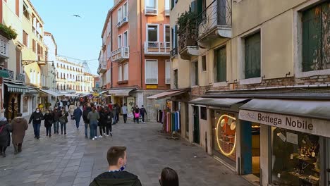 High-angle-view-of-people-walking-in-pedestrian-street-of-Cannaregio-district,-Venice-in-Italy