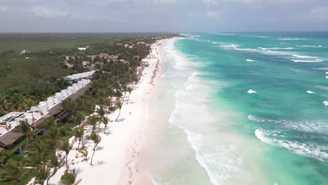 Aerial-drone-flying-over-a-long-beach-in-Tulum,-Mexico