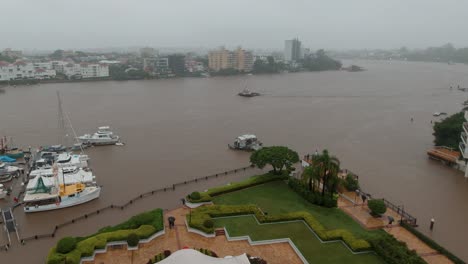 A-tug-boat-works-hard-against-the-surging-currents-at-it-heads-up-the-Brisbane-River-during-the-relentless-rain-deluge-that-led-to-the-2022-Brisbane-floods