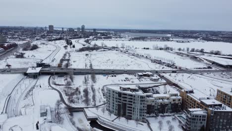 Aerial-View-Of-Snow-covered-Landscape-In-The-City-Of-Ottawa-In-Canada-With-Traffic-On-Highway-At-Winter