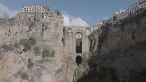 Aerial-view-of-dramatic-medieval-arch-bridge-over-gorge-in-Ronda-Spain