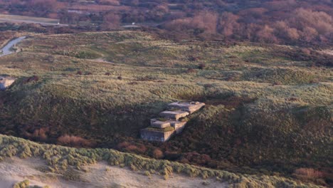 Old-abandoned-World-war-two-bunkers-in-Atlantikwall-hillside---aerial-parallax