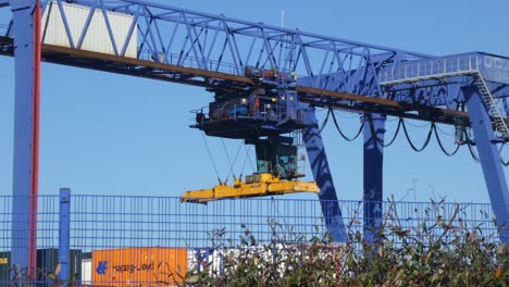 Shipping-container-crane-lift-loading-heavy-cargo-shipyard-crate-containers-for-export