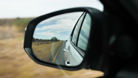 A-rearview-mirror-through-which-you-can-see-the-road-and-the-surroundings