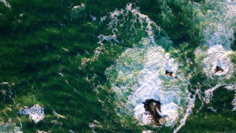 Aerial-Birds-Eye-Over-Dark-Green-Waves-Of-Pacific-Ocean-Approaching-Coastline-Of-Chiloe-Island