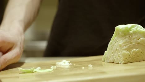 Slicing-Fresh-Cabbage-On-Wooden-Cutting-Board