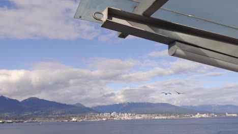 Seabirds-Flying-Over-Burrard-Inlet-At-Daytime-In-Vancouver,-BC,-Canada