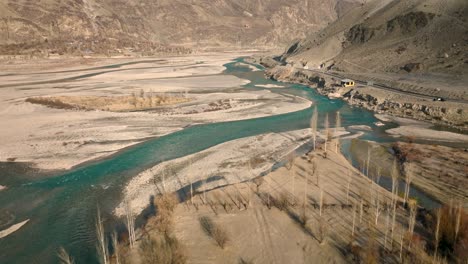 Drone-Flying-Over-Turquoise-Winding-River-Rising-To-Reveal-Sweeping-Valley-Landscape-Of-Ghizer-Valley-Of-Gilgit-Baltistan