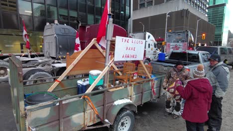 Protesters-talk-by-Canadian-flagged-truck-at-Freedom-Convoy-protests
