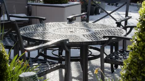 Hail-defrosting-on-a-garden-lounge-table-in-the-UK