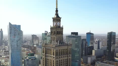 Aerial-view-around-the-clock-tower-on-The-Palace-of-Culture-and-Science,-in-Warsaw,-Poland---orbit,-drone-shot