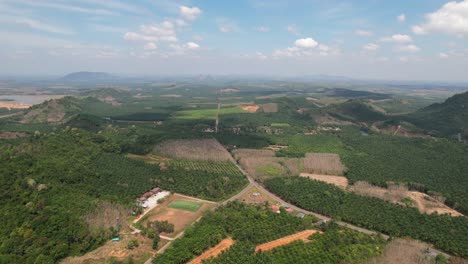 Aerial-drone-of-a-large-green-valley-in-the-rural-mountain-region-of-Krabi-Thailand-on-a-sunny-day