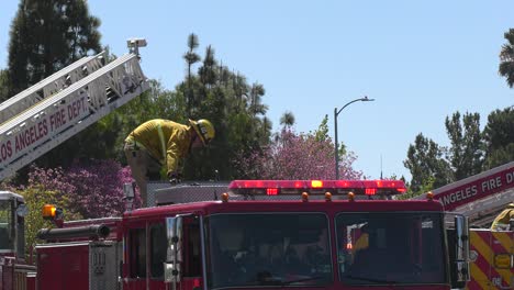 firefighters-climb-on-ladder-of-truck
