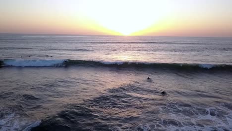 Slow-motion-of-surfers-after-burial-at-sea-during-sunset