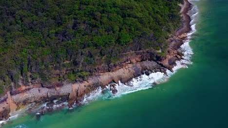 Tropical-Ocean-Waves-Crashing-Onto-Rocks-On-The-Noosa-Heads-In-Queensland,-Australia---aerial-drone-shot
