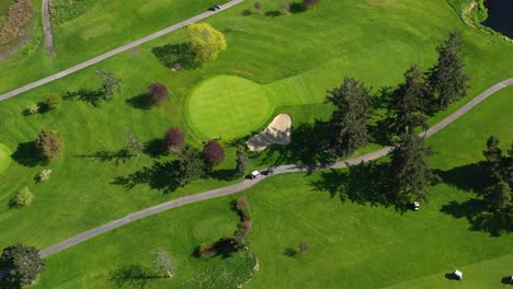 Aerial-of-golfers-going-out-onto-the-green-to-putt