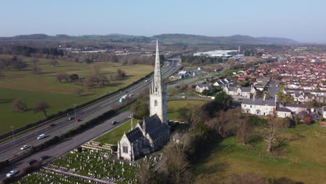 An-aerial-view-of-the-marble-church-in-Bodelwyddan-on-a-sunny-morning,-flying-left-to-right-around-the-church,-Denbighshire,-North-Wales,-UK