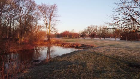 Golf-Course-Ponds-At-Calm,-Foggy-Sunset-In-Fall-In-America