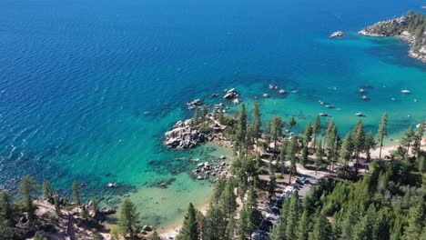 Turquoise-Water-And-Trees-On-The-Shore-At-Lake-Tahoe-In-The-USA---aerial-drone-shot
