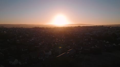 AERIAL:-Sunset-pan-out-over-small-sub-urban-housing-estate,-Swansea,-4k-Drone