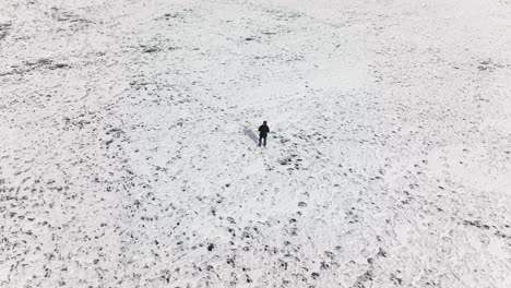 Lone-Male-Walking-And-Standing-Still-On-Snow-Covered-Ground-At-Khalti-Lake