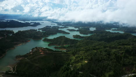 Slow-cinematic-aerial-footage-over-the-green-landscape-of-Guatape-lake-in-Colombia