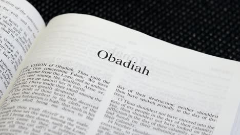 Close-Up-Shot-of-Bible-Page-Turning-to-the-book-of-Obadiah