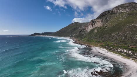 Unspoilt-sandy-beach-at-Misty-Cliffs,-jagged-Cape-Peninsula-coastline