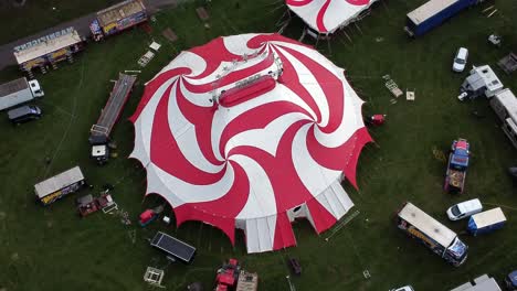 Planet-circus-daredevil-entertainment-colourful-swirl-tent-and-caravan-trailer-ring-aerial-view-Birdseye-orbit-left