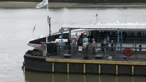 Commuters-And-Passengers-Boarding-Uber-River-Boat-At-Greenwich-Pier-On-Cloudy-Day