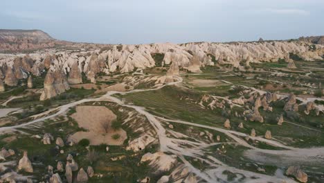 Aerial-drone-rotating-shot-over-scenic-landscape-with-rocks-unusual-a-formation-called-fairy-chimneys-in-Goreme,Cappadocia,-Turkey