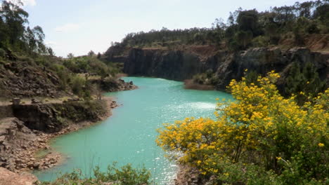 Lagoon-formed-in-the-old-quarry-of-Maiorca,-next-to-the-Mondego-fields,-Figueira-da-Foz,-Portugal---Top-view