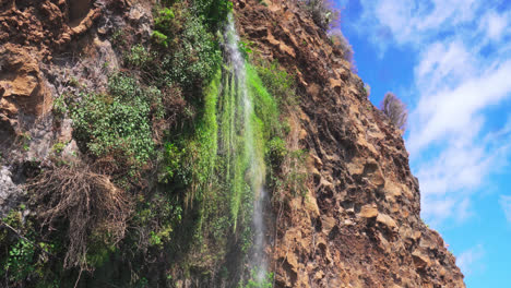 Small-stream-of-water-falling-from-the-steep-mountain