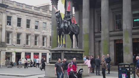 Slow-motion-of-people-gathered-around-the-Duke-of-Wellington-statue