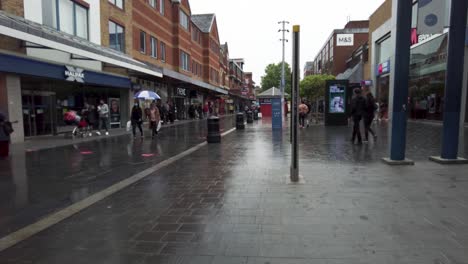 View-Of-Shoppers-Walking-Along-St-Anns-Road-In-Harrow-On-Rainy-Day-On-15-May-2022