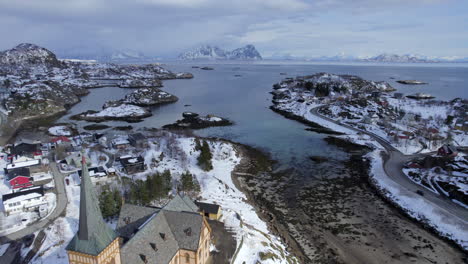 Forwarding-Aerial-shot-off-Lofoten-Cathedral-on-a-scenery-moody-winter-day-with-scenic-mountains,-Lofoten-Island,-Norway