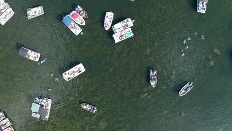 Aerial-top-down,-spring-break-party-boats-crowded-on-a-lake-during-summer-holiday